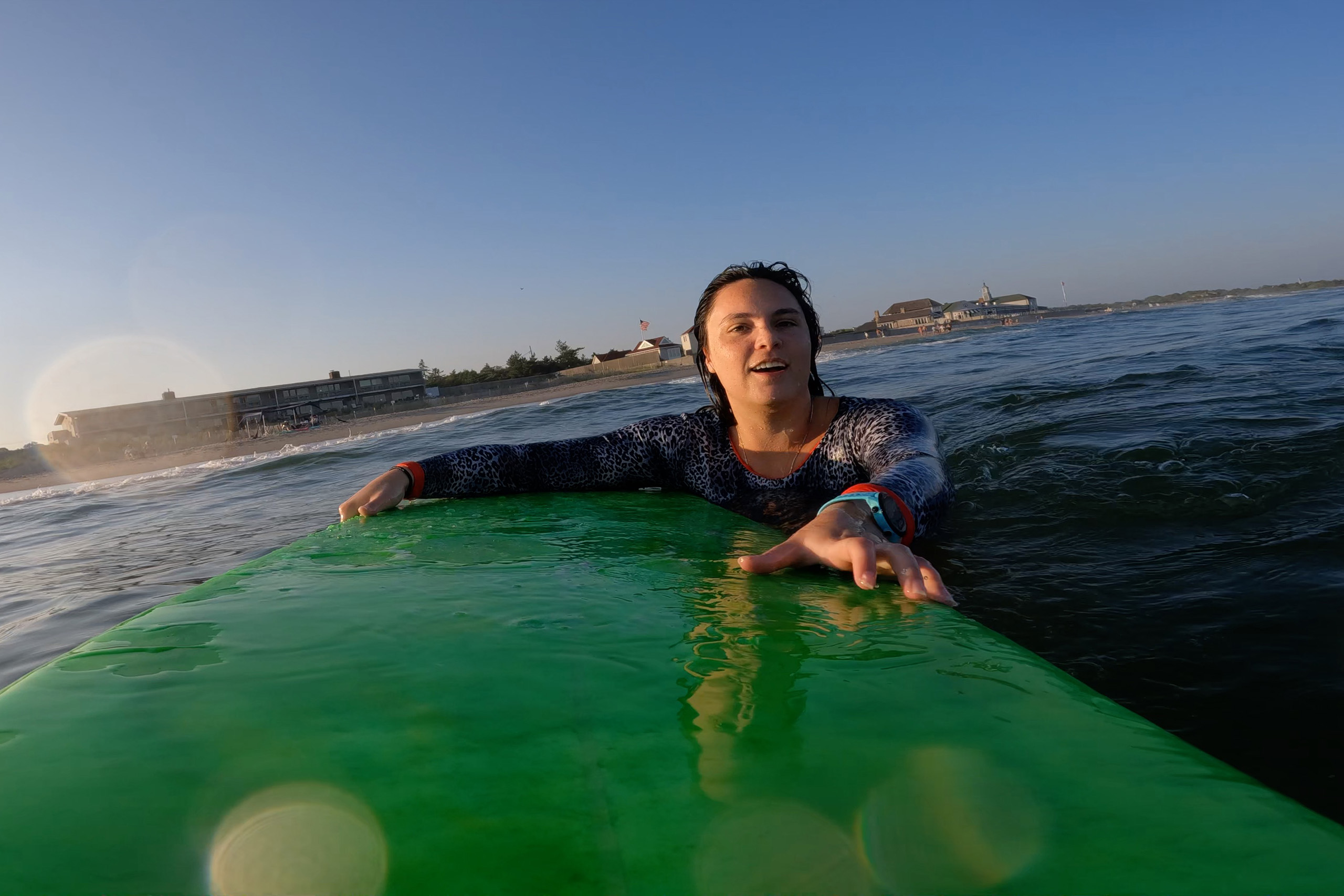 Amelia floating on her surfboard