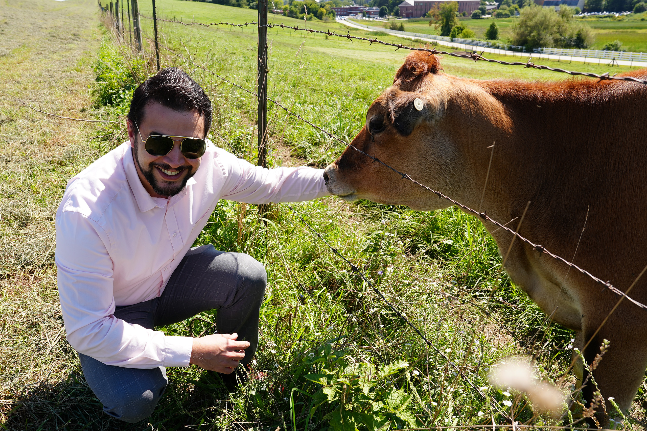 Breno Fragomeni posing with a cow