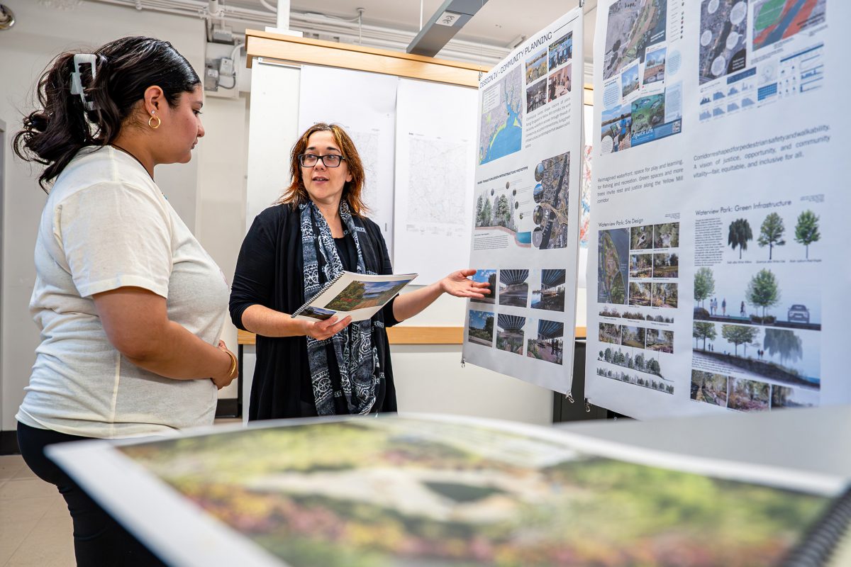 professor and student looking at landscape architecture plans