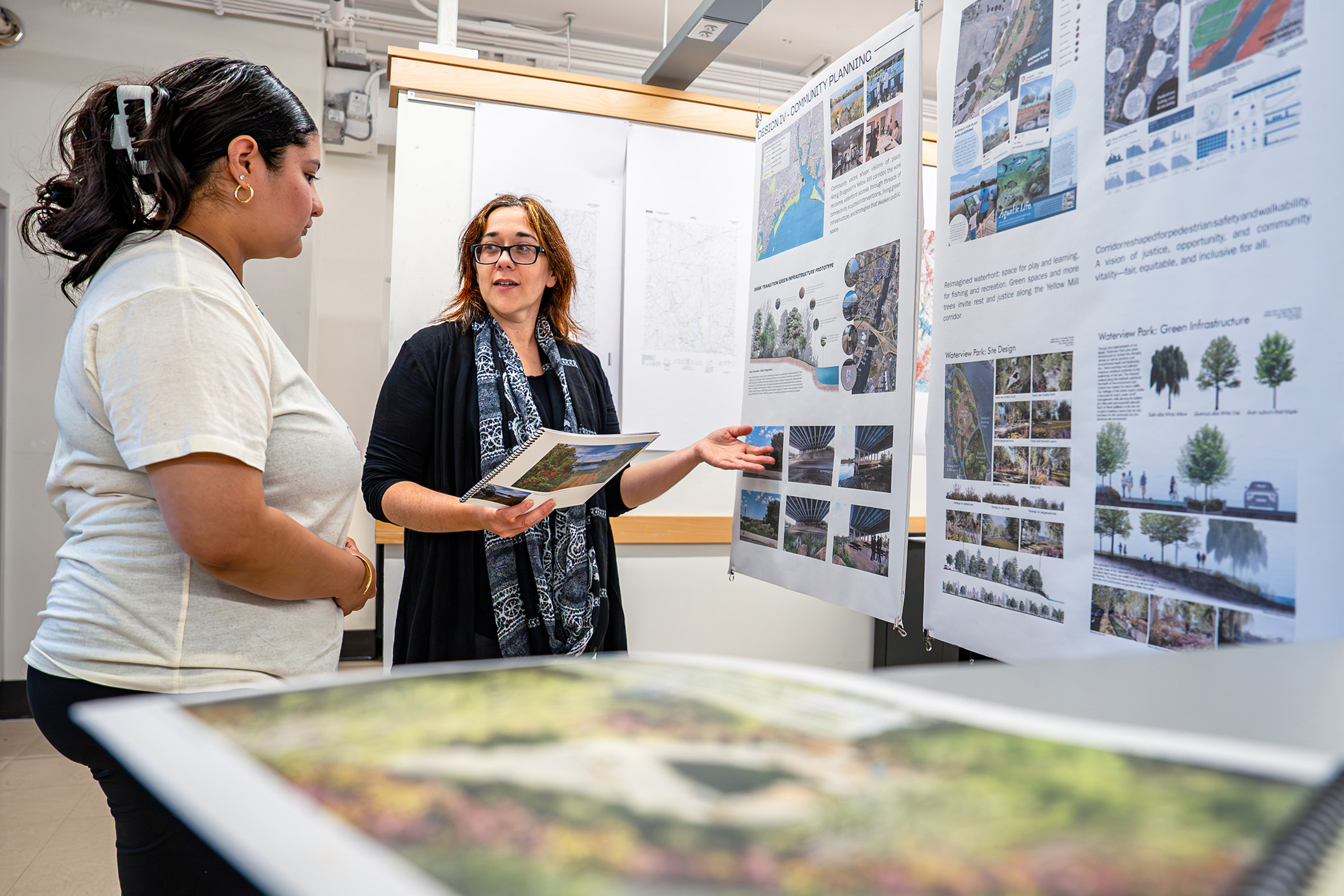 professor and student looking at landscape architecture plans