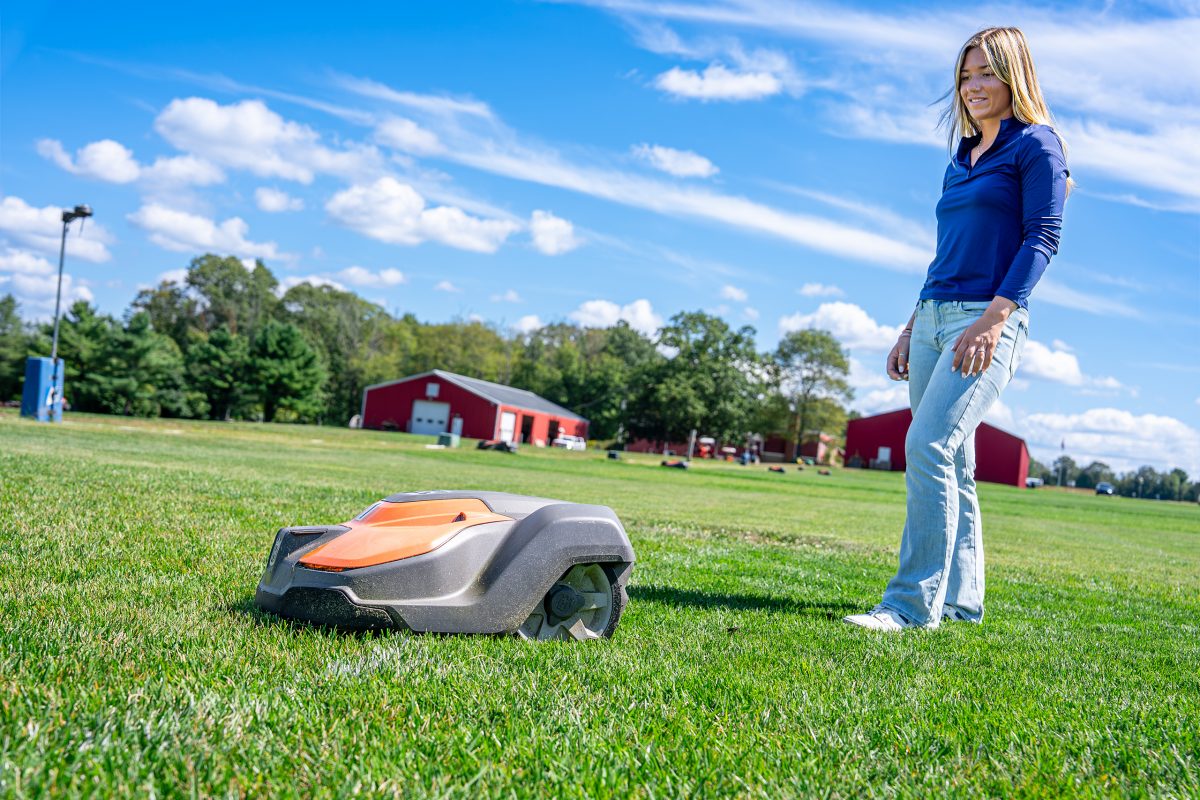 Tessa Hospod following an autonomous lawn mower