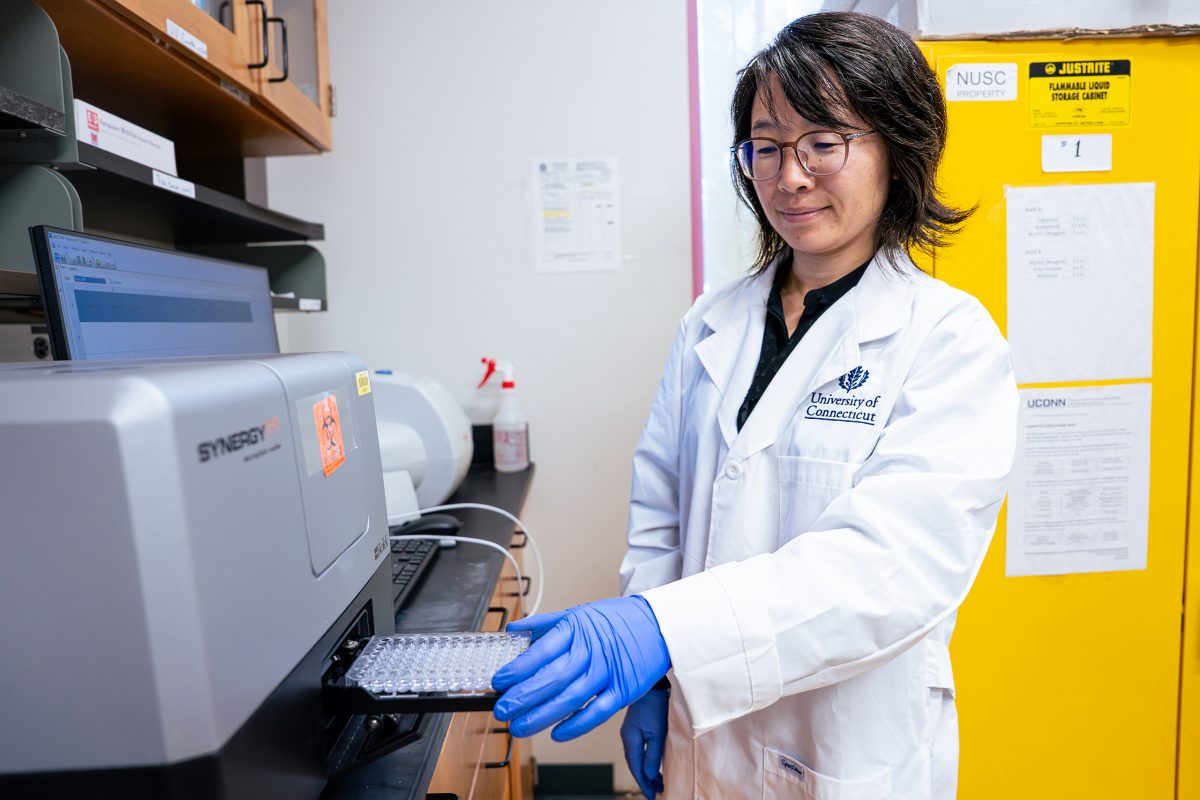 Zhenlei Xiao processing samples in a lab