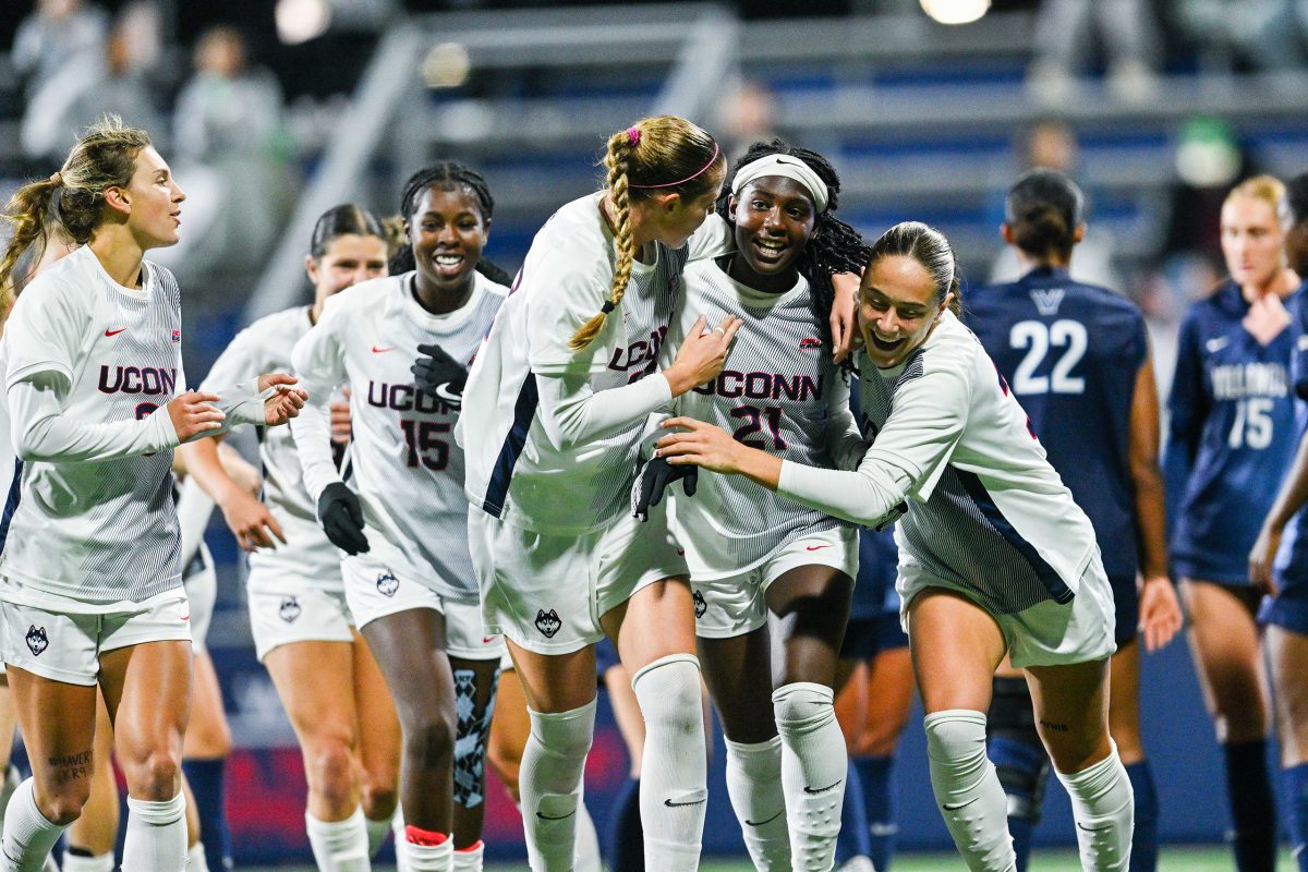 UConn women's soccer team celebrates a victory